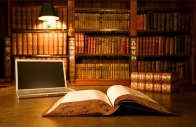 image of law library with book and laptop on table.